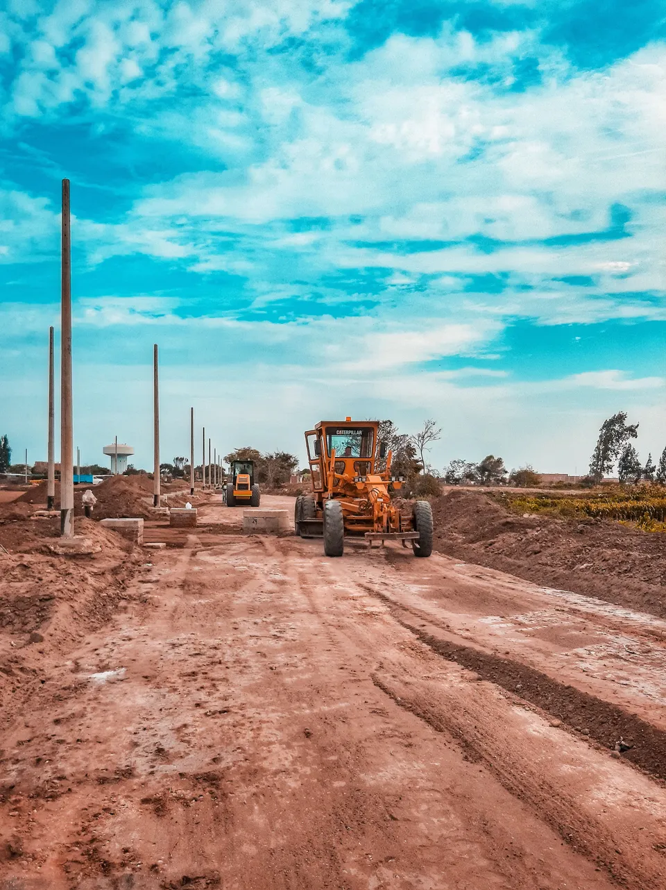 Road construction with motor grader